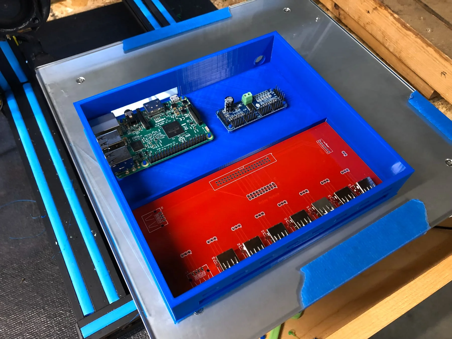 Blue and red controller enclosure during component fit testing